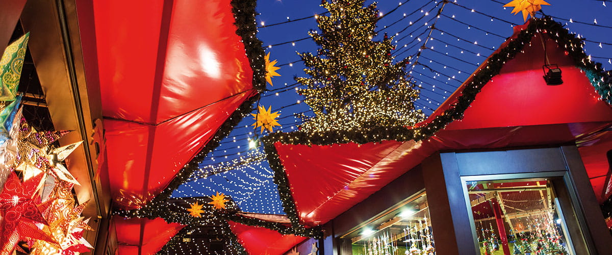 Red canopies and twinkling lights of the Christmas market in Germany, Cologne